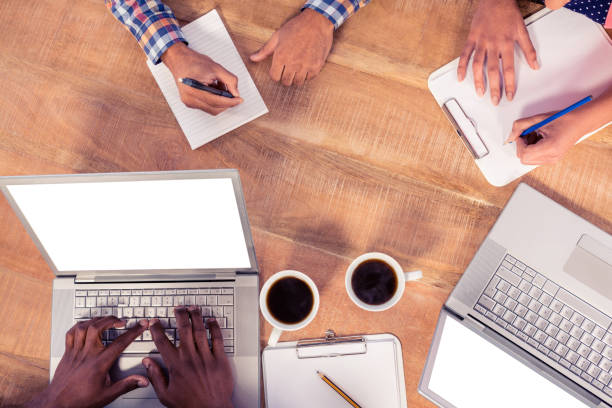 istock High angle view of business people working 700795062
