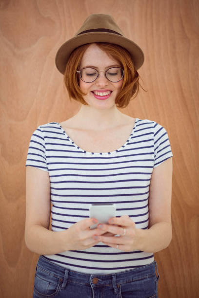 istock smiling hipster woman on her smartphone 700799404