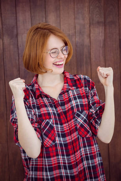 istock smiling hipster woman celebrating a victory 700799464