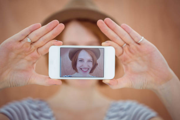 istock smiling hipster woman taking a selfie 700799862