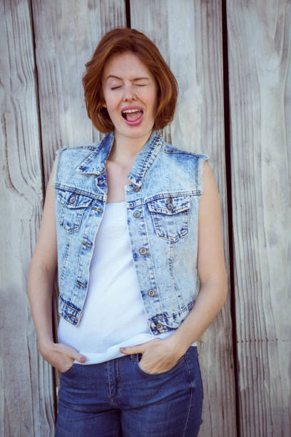 istock winking hipster woman with her hands in her pockets 700799920