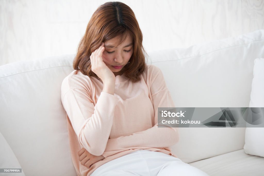 Woman sitting on a couch Women Stock Photo