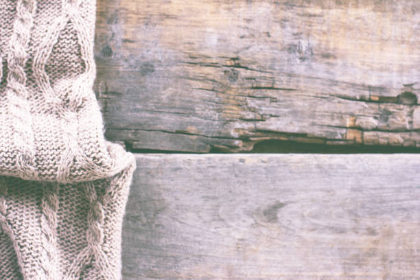 istock knitted plaid, sweater on old wooden boards 700806484