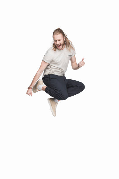 istock excited caucasian man jumping in black jeans, isolated on white 700806716