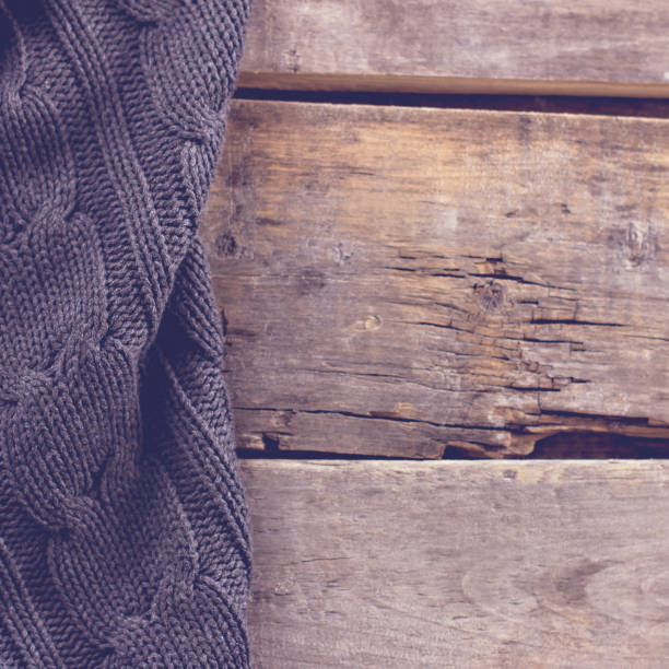 istock knitted plaid, sweater on old wooden boards 700806918