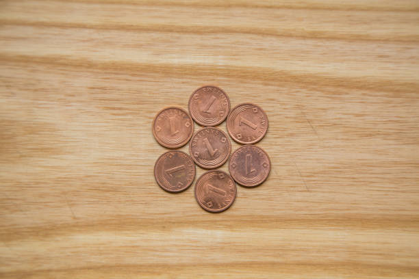 istock Old Latvian coins on a wooden backgrouns. Lats and centimes. 700807032