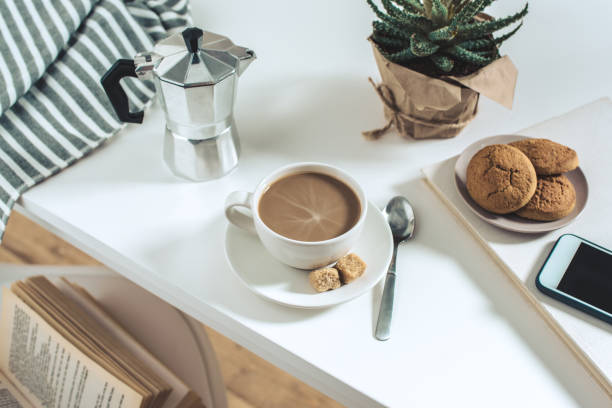 istock coffee cup with cookies and potted plant with smartphone on tabletop 700807866