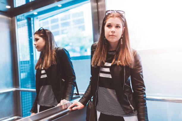 istock Trendy woman in an elevator 700813790