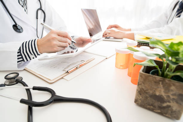 istock Men and women in white coats to work 700814288