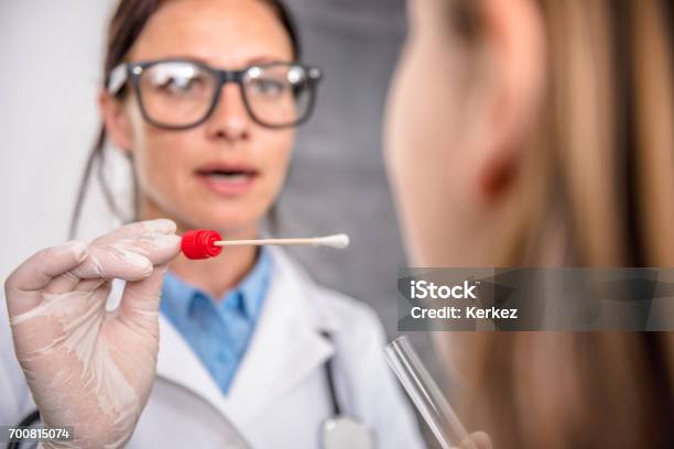 Female Doctor Taking A Throat Culture Stock Photo - Download Image Now - Cotton Swab, Medical Test, Flu Virus