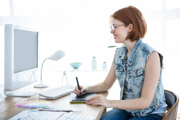 istock smiling hipster business woman writing on her tablet 700818350