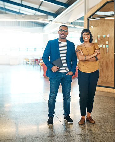 Portrait of two young designers standing together in an office