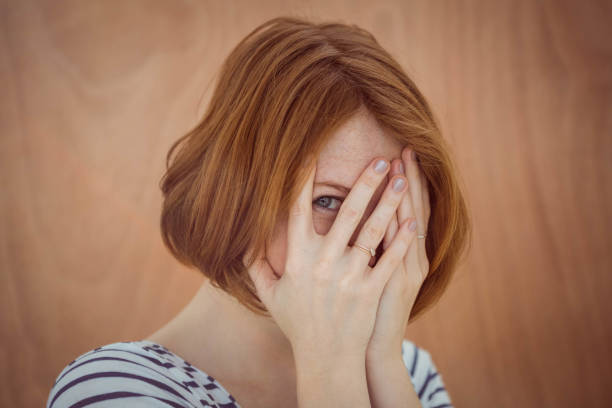 istock beautiful hipster woman hiding her face 700818488