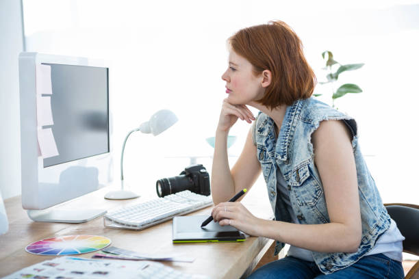 istock smiling hipster photographer on her tablet 700818698