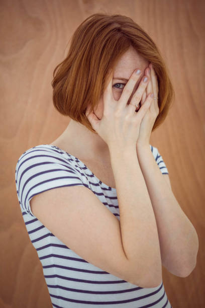 istock beautiful hipster woman hiding her face 700818768
