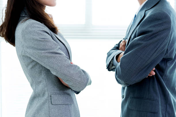 Two businesspeople standing face to face Two businesspeople standing face to face confrontation stock pictures, royalty-free photos & images