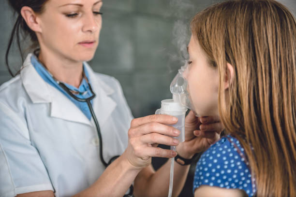 istock Little girl having nebulizer treatments 700825654