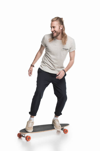 istock young blond skater riding longboard isolated on white 700827870