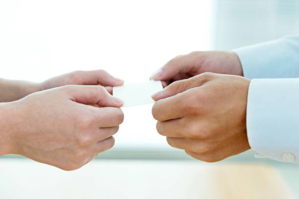 istock Businesspeople pass a business card 700828694
