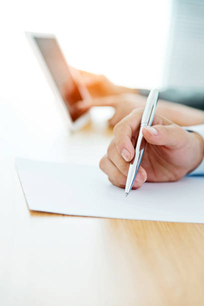 istock Businessman writing on paper 700828846