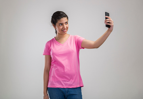 a girl child or teenage girl taking selfie in style