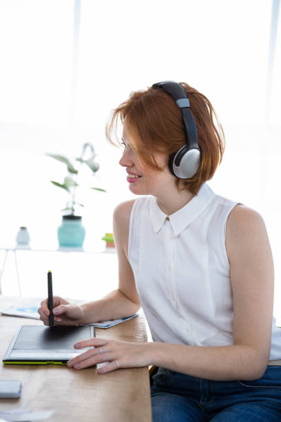 istock smiling hipster businesswoman writing on a digital drawing tablet 700840958