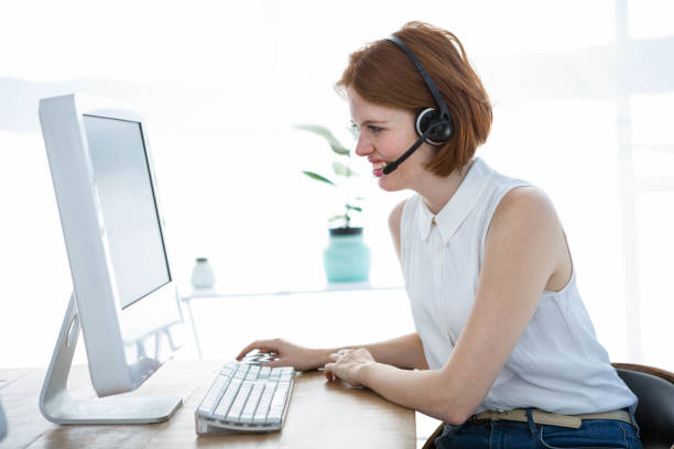 istock grimacing hipster business woman looking at her computer 700841218