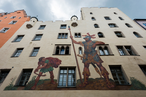 Regensburg, Germany - Mai 25, 2017: Painting of David and Goliath in middle of the old town from the historic City Regensburg. The building with the painting is called Goliath building. Painted from Melchior Bocksberger in 1573.