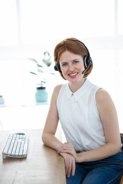 istock smiling hipster business woman wearing a headset 700841286