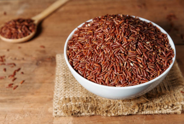 istock Rice berry in white bowl on wooden background 700847494