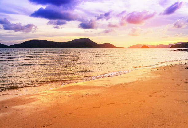 istock Beach sand in twilight with sea sunset and sunbeam 700847510