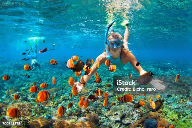 Happy Couple Snorkeling Underwater Over Coral Reef Stock Photo - Download Image Now - Snorkeling, Snorkel, Bali