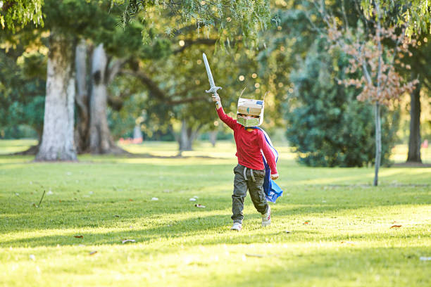 istock Young boy playing in Autumn leaves 700850152