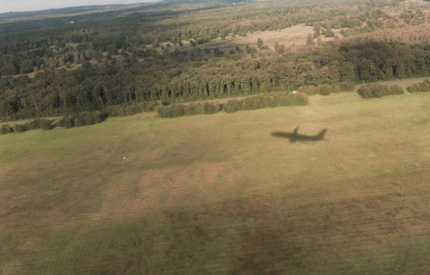 istock Shadow Of Airplane On Field 700852565