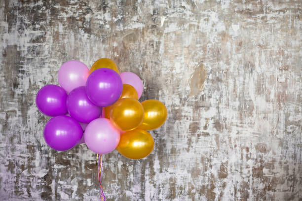 istock Bright balloons bunch against a textured wall 700861840