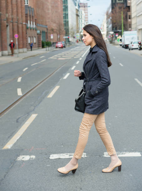 istock Woman crossing street in profile 700861902