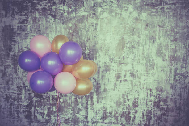 istock Bright balloons bunch against a textured wall 700862498