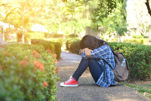 istock Sad Woman Sitting On The Ground 700863789