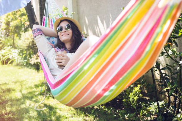 istock Smiling girl resting in hammock 700865422