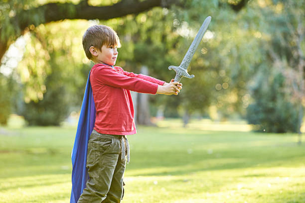 Young boy playing in Autumn leaves
