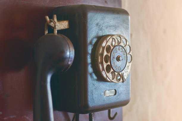 istock Retro rotary dial phone hanging on the wall 700869496