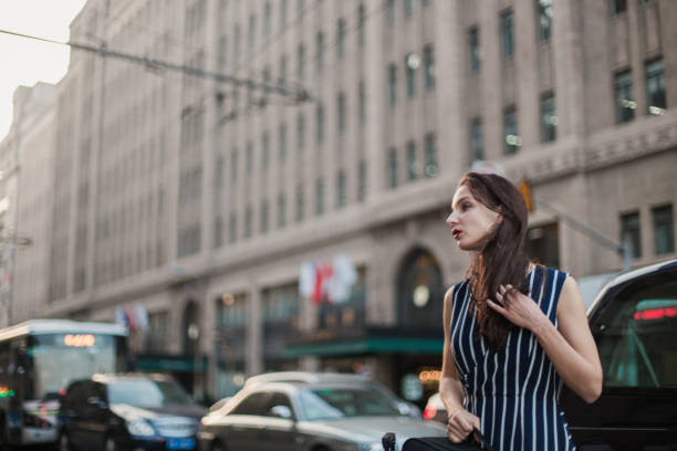 istock Young lady traveling with a suitcase 700870576