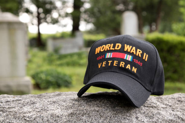 istock World War Two Cap among  gravestones  with cemetery in background 700870716