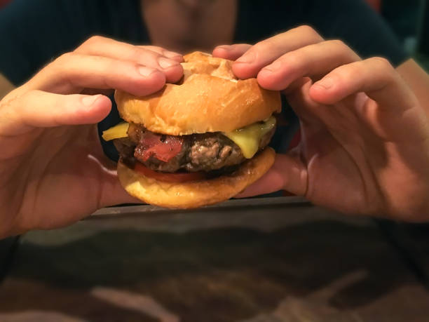 istock Men holding tasty burger 700875786