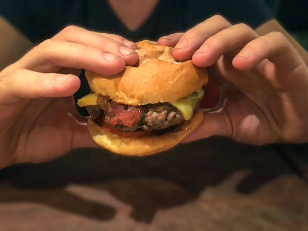 istock Adult men eating burger 700875790
