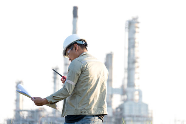 istock The man engineer reading  the drawing paper construction for plan work at power plant, Thailand.  Engineer Concept. 700875868