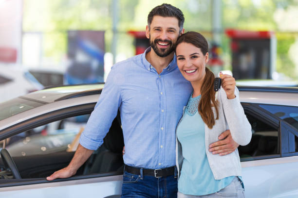 istock Young couple buying a car 700892028