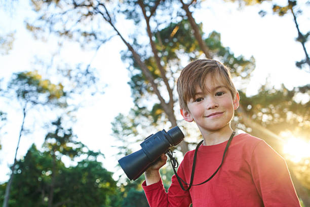 istock Young boy playing in Autumn leaves 700892072