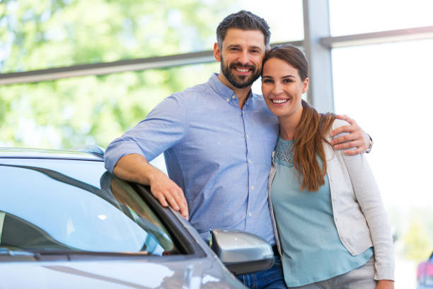 istock Young couple buying a car 700892082