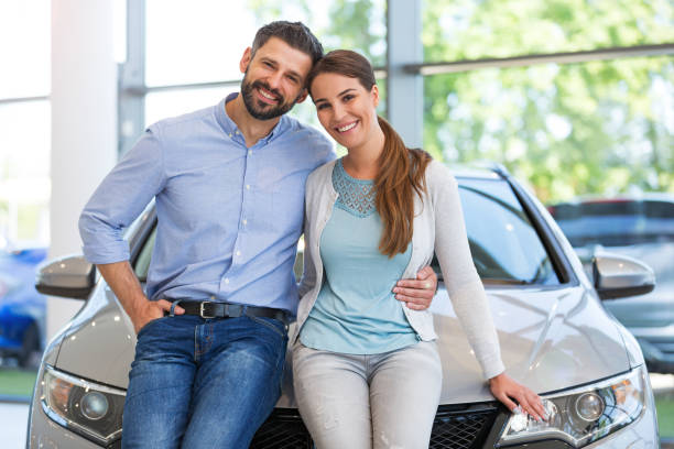 istock Young couple buying a car 700892150